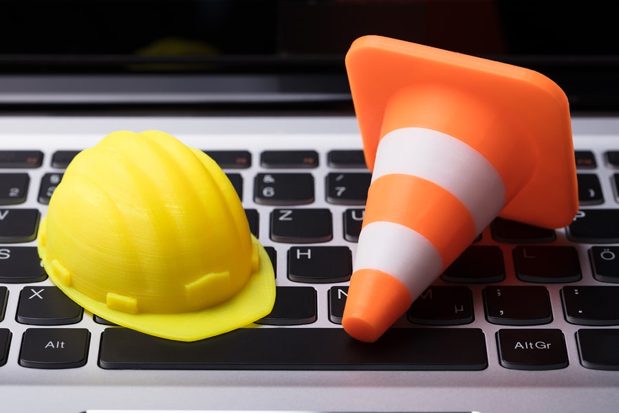 Image of a hard hat and a construction cone
